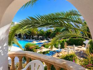 a view of the pool from the balcony of a resort at Le Corail Apart'Hotel & Splash Park in Hammamet