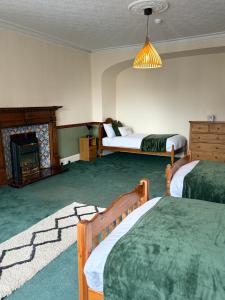 a hotel room with two beds and a fireplace at Kinkell House in Inverness +81 photos
