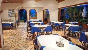a restaurant with tables and chairs with blue table cloth at Pansion Klaudija in Crikvenica +38 photos