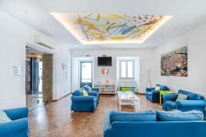 a living room with blue couches and a ceiling at HI Évora – Pousada de Juventude in Évora