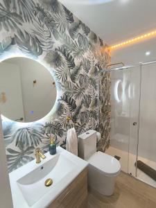 a bathroom with a toilet and a sink and a mirror at Casa Torrox Costa cerca del mar in Torrox +21 photos