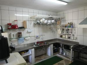 a kitchen with a large stainless steel counter top at sitio Ibiúna in Ibiúna