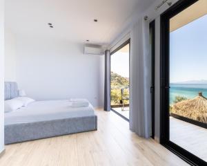 a bedroom with a bed and a view of the ocean at Oceanfront Oasis in Borsh