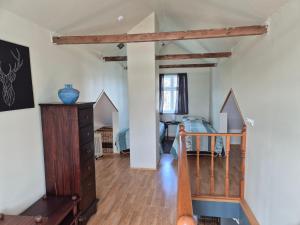a living room with a staircase and a room with a table at Steinhúsið in Hólmavík