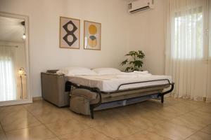 a bedroom with a bed in the corner of a room at Diame Suite - Tzivelekidou in Chrysoupolis