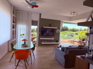 a living room with a table and a couch at Villa Evita , penthouse, 53m2 ,Athytos , astonishing sea view in Afitos