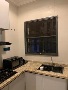 a kitchen with a sink and a window at Valley in Kado