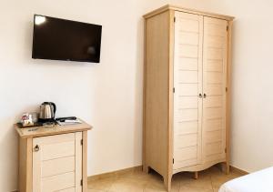 a bedroom with a cabinet and a tv on the wall at B&B Marina Sleep And Ship in Rodi Garganico +37 photos