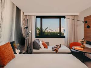 a hotel room with a bed and a window at Novotel Paris Vaugirard Montparnasse in Paris +219 photos