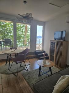 a living room with two tables and a television at Moreto in Slano