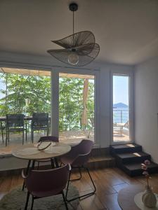 a living room with a table and chairs and a large window at Moreto in Slano