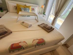 a large bed with two pillows on it in a bedroom at Villa Evita , penthouse, 53m2 ,Athytos , astonishing sea view in Afitos