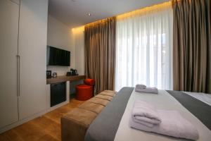 a hotel room with a bed and a window at Comfort Boutique Hotel in Tirana