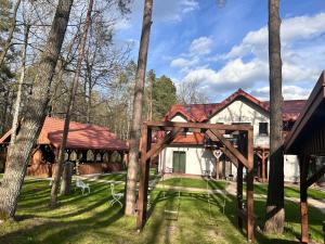 a house in the woods with a gazebo at Leśna Weranda pokoje gościnne FB Leśna Weranda in Ruciane-Nida