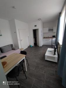 a living room with a couch and a table at Holidayapartment Bella Napoli in Liblar +24 photos