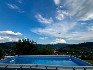 a swimming pool with a view of the mountains at Vershok villa in Slavske