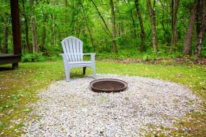 a white chair sitting next to a fire hydrant and a manhole istg at Wren's Nest in Logan