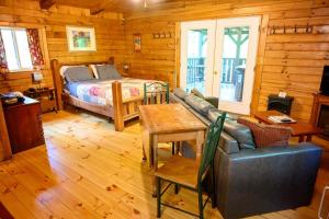 a living room with a bed and a couch at Wren's Nest in Logan +11 photos
