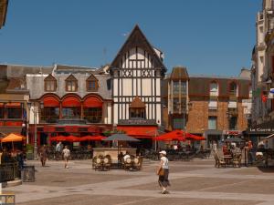 a person walking down a street in a city at ibis Saint Quentin Centre Basilique in Saint-Quentin
