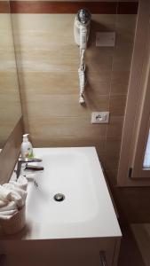 a bathroom with a white counter top and a camera at Boschetto di Campagna in Castagnole
