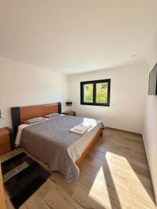 a bedroom with a large bed with a window at Paraíso Céu Azul in Celorico de Basto +58 photos