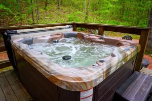 a hot tub sitting on top of a deck at Bear Hollow in Logan