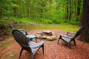 three chairs sitting in front of a fire pit at Bear Hollow in Logan