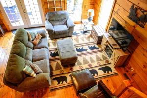 an overhead view of a living room with a couch and chairs at Bear Hollow in Logan +15 photos