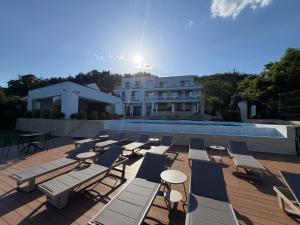 a group of lounge chairs and a swimming pool at YRYS House - Adults Only in Eşelniţa