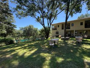 a yard with a table and chairs in front of a building at Hotel Rural Xerete in Navaconcejo