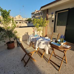 a table and chairs on top of a balcony at TOP1 Templum Luxuriae in Reggio di Calabria