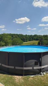 a large swimming pool on top of the grass at Slavotova hiža in Mračin