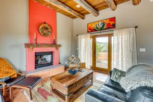 a living room with a couch and a fireplace at Adobe-Style Taos Home with Great Views! in Taos