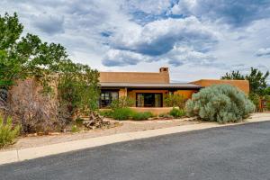 a house with a road in front of it at Adobe-Style Taos Home with Great Views! in Taos