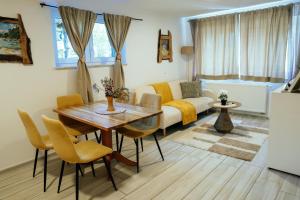 a living room with a table and a couch at Montis Bled in Bled