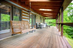 a porch of a house with a swing at Moonlight Ridge in Laurelville