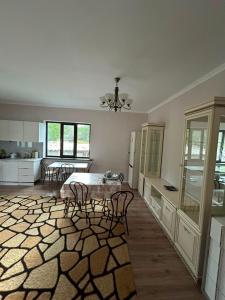 a kitchen with a table and chairs in a room at Kolsai Terrassa in Saty