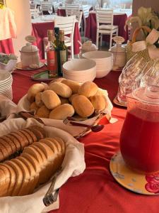 a table with hot dogs and sausages on a red table cloth at La Quiete Park Hotel in Manerba del Garda +48 photos