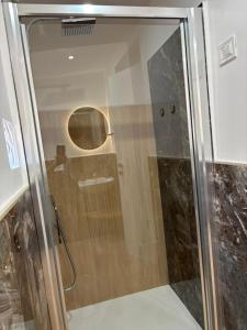 a shower with a glass door in a bathroom at Amarè House in Catania +23 photos