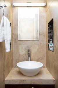 a bathroom with a white bowl sink on a counter at La Casita Perfect Location in Cozumel +20 photos