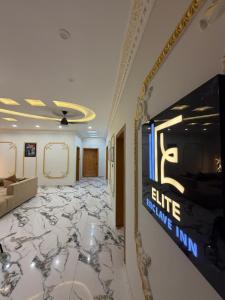 a living room with a marble floor and a wall at Elite Enclave inn in Islamabad