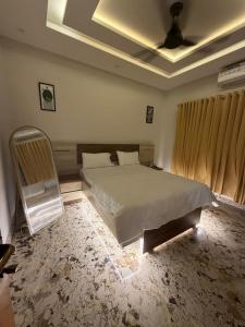 a bedroom with a bed and a chair in it at Elite Enclave inn in Islamabad