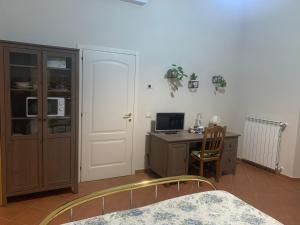 a bedroom with a desk and a bed and a computer at Il Quadrifoglio Nascosto in Pontassieve