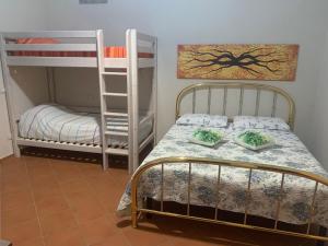 a room with two bunk beds and a bed with pillows at Il Quadrifoglio Nascosto in Pontassieve