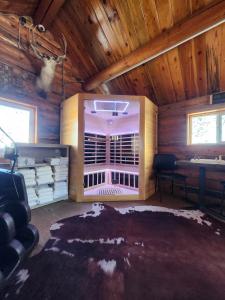 a living room with a large window in a wooden room at Elk Antler Inn in Thermopolis