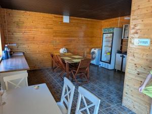 a kitchen and dining room with a table and a refrigerator at Mara si Marea in Năvodari