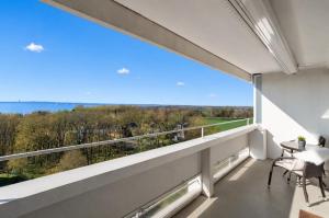 a balcony with a view of the woods at Leuchtturm-Loft mit Meerblick in Sierksdorf