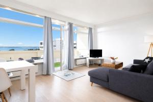a living room with a view of the ocean at Panoramic App A06-6 in Sierksdorf