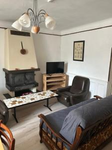 a bedroom with a bed and a chair and a stove at LEMAFIOlY in Cemboing