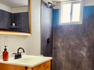 a bathroom with a sink and a shower at Elk Antler Inn in Thermopolis